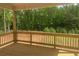 View of the wooden back porch with green foliage and beautiful nature views at 306 Rodeo Dr, Auburn, GA 30102