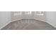 Well-lit bedroom featuring gray carpet and white trim at 306 Rodeo Dr, Auburn, GA 30102