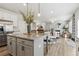 Open concept kitchen with island, granite countertops, stainless steel appliances, and an open view to the living room at 306 Rodeo Dr, Auburn, GA 30102