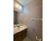 A compact half bathroom featuring a sink with wallpaper design at 905 Park Ne Pl, Conyers, GA 30012