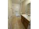 Bathroom with tub-shower combo, toilet, and vanity with a sink and traditional wallpaper at 905 Park Ne Pl, Conyers, GA 30012