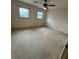A spacious bedroom with multiple windows, and a ceiling fan at 905 Park Ne Pl, Conyers, GA 30012