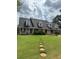 Inviting exterior with dormer windows, lush green lawn, and stepping stone walkway at 905 Park Ne Pl, Conyers, GA 30012