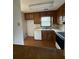Functional kitchen design with wood cabinets, and a classic window view at 905 Park Ne Pl, Conyers, GA 30012