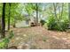 A backyard and pathway leading to the deck, with large trees surrounding the home at 110 The Farm Rd, Mcdonough, GA 30252