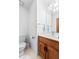 Powder room with white walls, single sink vanity, with a wooden cabinet, and white tile floor at 110 The Farm Rd, Mcdonough, GA 30252