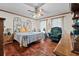 Charming bedroom featuring wood floors, a ceiling fan, and soft, natural light at 110 The Farm Rd, Mcdonough, GA 30252