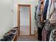 Walk-in closet with shelving and rod space for clothes storage, with an additional storage room at 110 The Farm Rd, Mcdonough, GA 30252