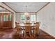 Dining room with hardwood floors, classic chandelier, large window and access to the foyer at 110 The Farm Rd, Mcdonough, GA 30252