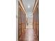 Hallway between bedroom and bathroom with wood floors, wooden doors, and recessed lights at 110 The Farm Rd, Mcdonough, GA 30252