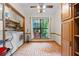 Spacious laundry room with tile floors, large window, washer, dryer, folding table, and storage shelves at 110 The Farm Rd, Mcdonough, GA 30252