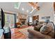 Bright living room showcasing a stone fireplace, hardwood floors, skylights, and French doors to the outside at 110 The Farm Rd, Mcdonough, GA 30252
