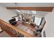 Cozy living room with vaulted ceilings, wood beam, stone fireplace, hardwood floors, and ample natural light at 110 The Farm Rd, Mcdonough, GA 30252