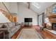 Spacious living room featuring a stone fireplace, hardwood floors, and a staircase to the upper level at 110 The Farm Rd, Mcdonough, GA 30252