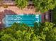 Aerial view of a swimming pool surrounded by lush trees and a pergola at 1195 Milton Ter # 1304, Atlanta, GA 30315