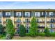 Multi-story condo building featuring private balconies, lush landscaping, and a well-maintained lawn at 1195 Milton Ter # 1304, Atlanta, GA 30315
