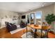 Inviting living room featuring hardwood floors, a dining area, and a balcony with scenic views at 1195 Milton Ter # 1304, Atlanta, GA 30315