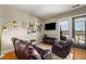 Cozy living room with hardwood floors, access to a balcony with city views, and comfortable seating at 1195 Milton Ter # 1304, Atlanta, GA 30315