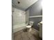 Bathroom featuring a tub with tile surround, a toilet, and a vanity at 4009 Ester Sw Dr, Atlanta, GA 30331