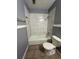 Bathroom featuring a tub with tile surround and a toilet at 4009 Ester Sw Dr, Atlanta, GA 30331