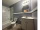 Bathroom featuring a tub with tile surround, a toilet, and a vanity at 4009 Ester Sw Dr, Atlanta, GA 30331