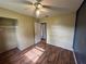 Bedroom features a ceiling fan, wood laminate floors, closet and paint ready for a new design at 4009 Ester Sw Dr, Atlanta, GA 30331