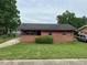 Charming single-story home featuring a brick facade, cozy porch, and well-maintained lawn at 4009 Ester Sw Dr, Atlanta, GA 30331