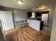 An eat-in kitchen featuring wood flooring, a refrigerator, and dark cabinets at 4009 Ester Sw Dr, Atlanta, GA 30331