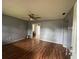 Spacious living room with hardwood floors, a ceiling fan, and ample natural light at 4009 Ester Sw Dr, Atlanta, GA 30331
