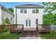 Home's back exterior, including a raised deck, with stairs leading to the lawn at 59 Stafford Nw St, Atlanta, GA 30314