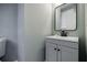 Powder room with gray vanity, black faucet, and a square mirror at 59 Stafford Nw St, Atlanta, GA 30314