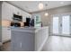 Kitchen has white shaker cabinets, black hardware, island seating, and herringbone backsplash at 59 Stafford Nw St, Atlanta, GA 30314