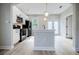 Kitchen area features an island and black appliances set against white cabinetry at 59 Stafford Nw St, Atlanta, GA 30314