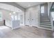 Open concept living room showing the stairs, doors, and kitchen area with pendant lighting at 59 Stafford Nw St, Atlanta, GA 30314