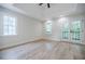 Bright main bedroom features vaulted ceilings, wood floors, and access to the balcony at 59 Stafford Nw St, Atlanta, GA 30314