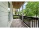 This covered porch has a wood ceiling, painted posts, and wooden railing at 59 Stafford Nw St, Atlanta, GA 30314