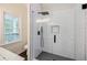 Bathroom shower with white subway tiles, black hardware and geometric tile floor at 59 Stafford Nw St, Atlanta, GA 30314
