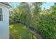 Spacious backyard with manicured lawn, mature trees, and a classic fence at 6084 Queens River Dr, Mableton, GA 30126