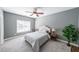 Bright bedroom with neutral colors, a ceiling fan, and a window letting in natural light at 6084 Queens River Dr, Mableton, GA 30126