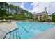 The sparkling community pool is surrounded by lounge chairs and manicured landscaping at 6084 Queens River Dr, Mableton, GA 30126