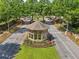 A gated entrance featuring a guard house with meticulous landscaping and flowers at 6084 Queens River Dr, Mableton, GA 30126