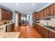 Spacious kitchen featuring stainless steel appliances, granite countertops, and dark wood cabinetry at 6084 Queens River Dr, Mableton, GA 30126