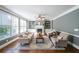 Bright living room with large windows, a cozy fireplace, built-in bookshelves, and comfortable seating at 6084 Queens River Dr, Mableton, GA 30126
