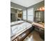 Spa-like main bathroom featuring a jacuzzi tub, dual sinks, and a large mirror at 6084 Queens River Dr, Mableton, GA 30126