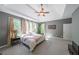 Main bedroom with tray ceilings, sitting area, and en-suite bathroom at 6084 Queens River Dr, Mableton, GA 30126