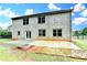 Back exterior featuring a patio, fire pit and wooded backyard at 9270 Colham Dr, Cumming, GA 30041