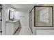 Modern bathroom featuring a tiled shower with glass door, granite counters, and neutral color palette at 9270 Colham Dr, Cumming, GA 30041