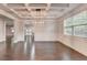 Elegant dining room with coffered ceiling, modern lighting, and hardwood floors at 9270 Colham Dr, Cumming, GA 30041