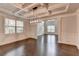 Elegant dining room with coffered ceiling, modern lighting, and hardwood floors at 9270 Colham Dr, Cumming, GA 30041