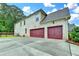 Three car garage with a large driveway at 9270 Colham Dr, Cumming, GA 30041